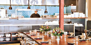  The Food Market’s open  kitchen overlooks the sleek dining room. Photography by Scott Suchman