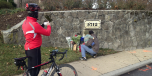  Bicyclists and friends continue to place flowers near the scene of the crash.—Photo by Ron Cassie