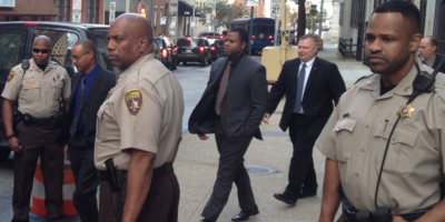  The trial Baltimore police officer William Porter (center, gray suit, black shirt), seen here leaving an earlier motion hearing, starts Monday.Photography by Ron Cassie